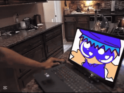 Person Typing On Laptop With Cartoon Character GIF