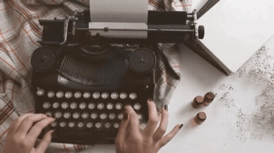 Person Typing On Old Typewriter With A B GIF