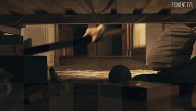 Person Under Bed With Resident Evil GIF