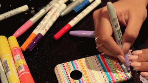 Person Using Sharpie To Decorate Cell Phone Case GIF