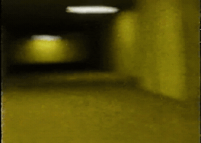 Person Walking Down Dark Hallway GIF
