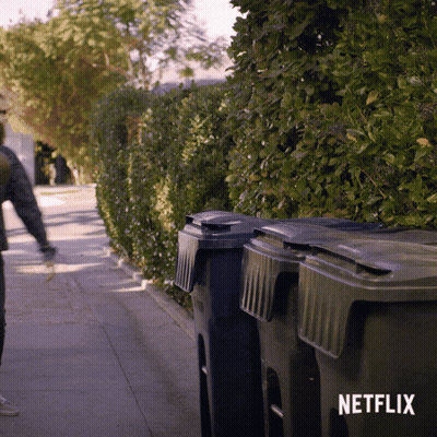 Person Walking Down Sidewalk With Netflix Logo GIF