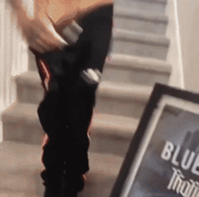 Person Walking Down Stairs Next To Blue Moon Sign GIF