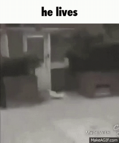 Person Walking Down Street With He Lives GIF