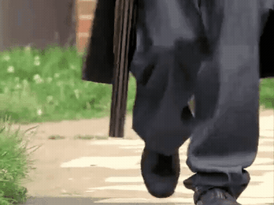 Person Walking Holding Shotgun GIF