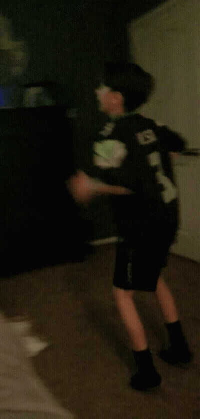 Person Walking In Dark Room With Red Star GIF