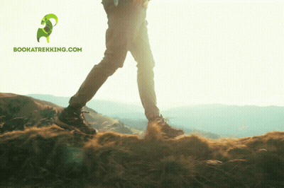Person Walking On Hill With Bookatrekking.com Logo GIF