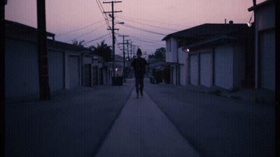 Person Walking On Street With Purple Sky GIF