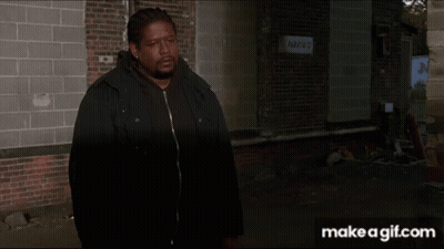 Person Walking Past Brick Building With Parking Sign GIF