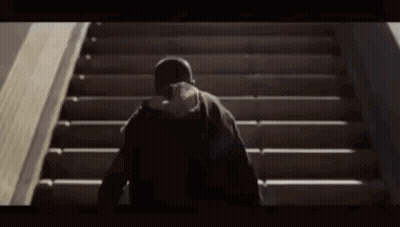 Person Walking Up Stairs With Hat GIF