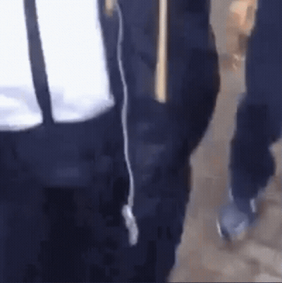 Person Walking With Stick And Another Behind GIF