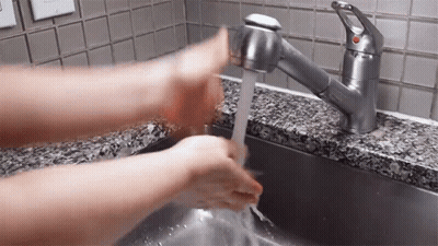 Person Washing Hands At Sink With Red Button GIF