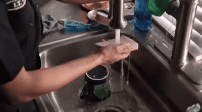Person Washing Mug In Kitchen Sink GIF