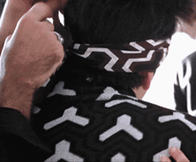 Person Wearing Black And White Headband With Arrows GIF