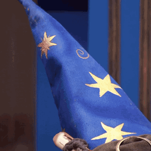 Person Wearing Blue Wizard Hat With Gold Stars GIF