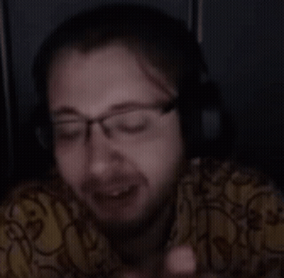 Person Wearing Glasses And Headphones Looking At Cell Phone GIF