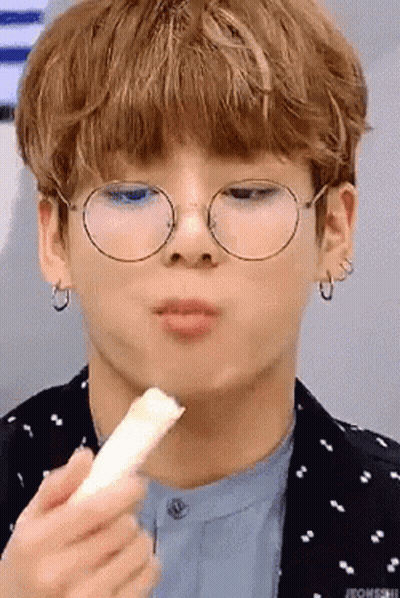 Person Wearing Glasses Eating Snack GIF