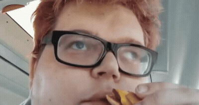 Person Wearing Glasses Eating Snack GIF