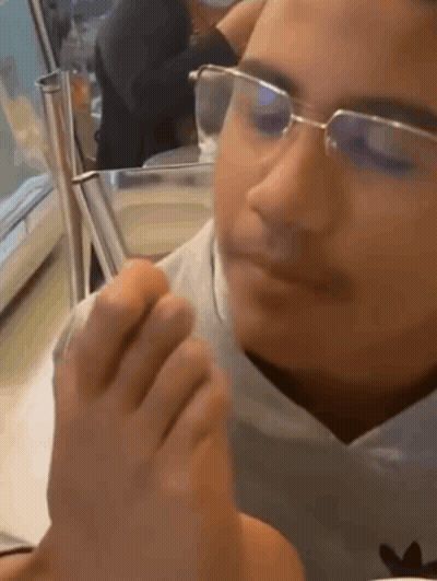Person Wearing Glasses Smelling Foot