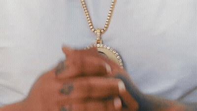 Person Wearing Gold Chain With Pendant GIF