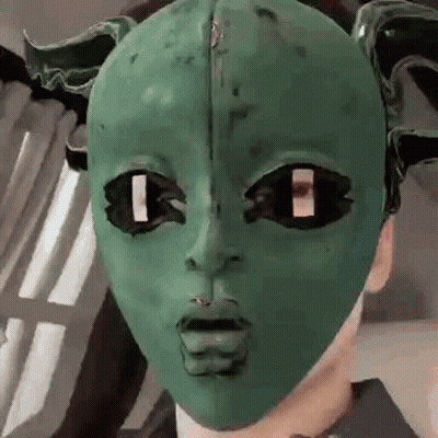 Person Wearing Green Horned Mask GIF