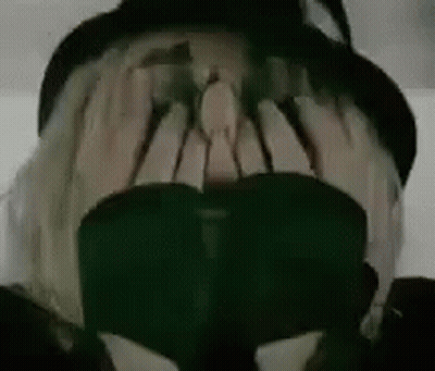 Person Wearing Hat And Sunglasses Covering Face GIF