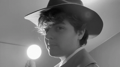 Person Wearing Hat Holding Light GIF