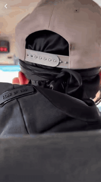 Person Wearing Hat With Fear Of God On Back GIF
