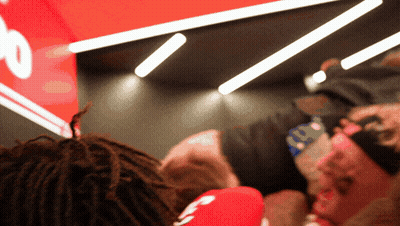 Person Wearing Headband With Number 10 In Front Of Red Sign GIF