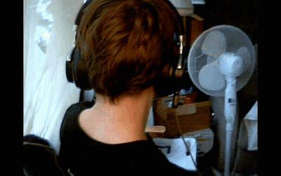 Person Wearing Headphones In Front Of Fan GIF