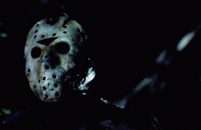 Person Wearing Jason Voorhees Helmet In Dark GIF
