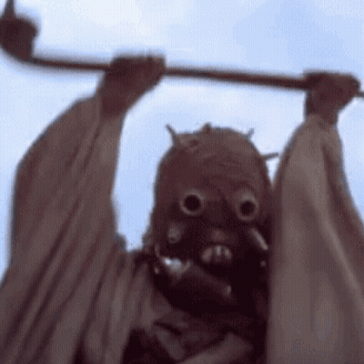 Person Wearing Mask Holding Stick GIF