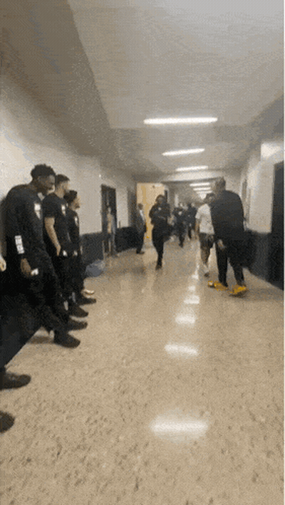 Person Wearing NBA Shirt in Hallway