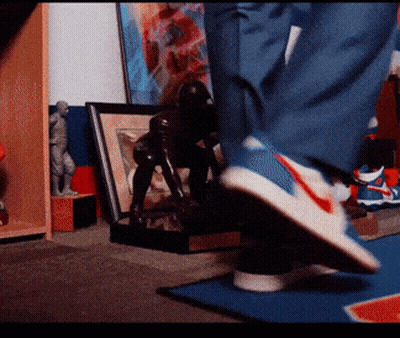 Person Wearing Nike Shoes On Blue Rug GIF