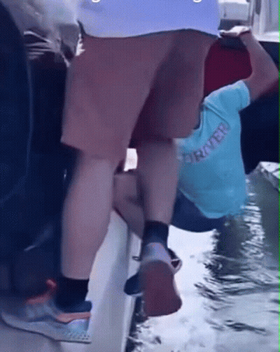 Person Wearing Rover Shirt Climbs Boat GIF
