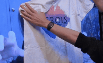 Person Wearing Watch Holding T-Shirt Saying Rois GIF