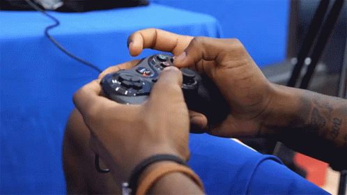 Person With Arm Tattoo Holding Game Controller GIF