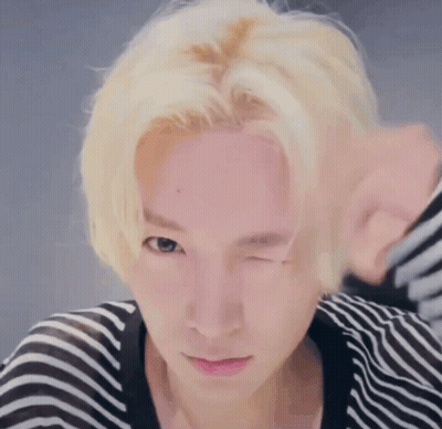 Person With Blonde Hair Winking GIF