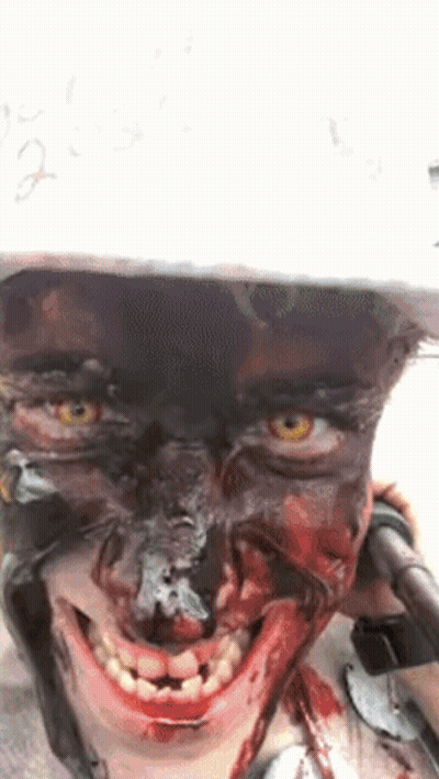 Person With Blood On Face In Helmet Smiling GIF