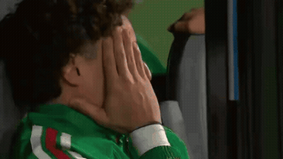 Person With Curly Hair Covering Face With Hand GIF