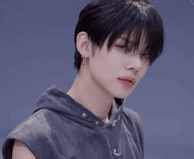 Person With Earrings And Sleeveless Hoodie GIF