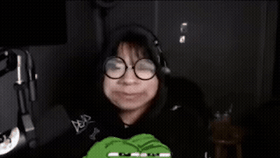 Person With Glasses And Headphones Holding Green Frog GIF