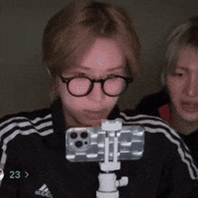 Person With Glasses Holding Phone On Tripod Number 23 GIF