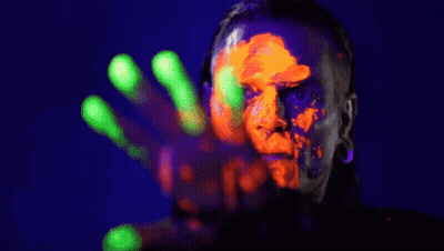 Person With Glow In The Dark Paint On Face And Hands GIF
