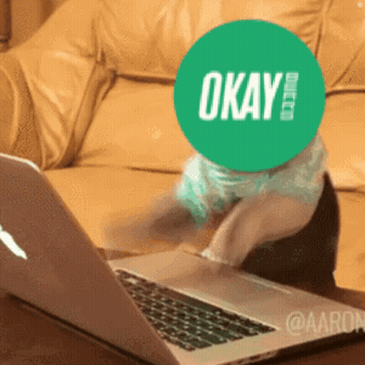 Person With Green OK Sticker On Face At Laptop GIF
