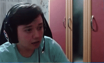 Person With Headphones And Microphone In Front Of Pink Cabinet GIF