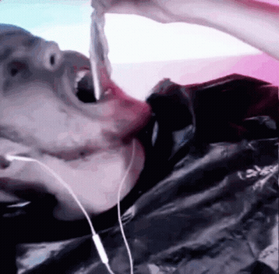 Person With Headphones Eating Meat GIF