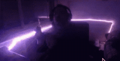 Person With Headphones In Dark Purple Room GIF