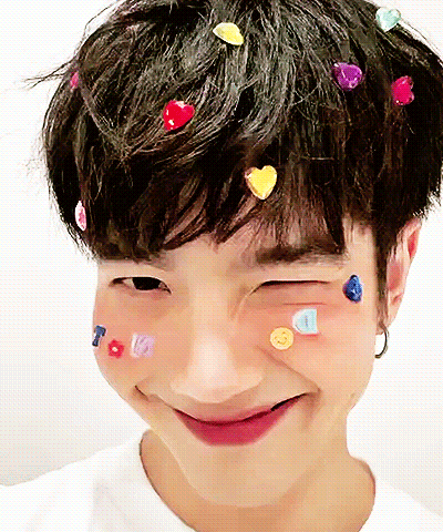 Person With Hearts In Hair And Smiley Faces GIF