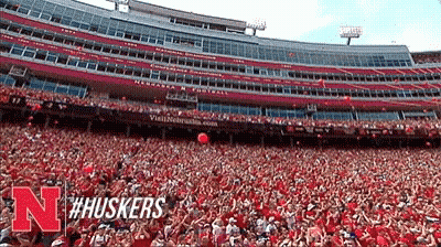 Person With Number 10 Headband In Front Of Red Sign GIF